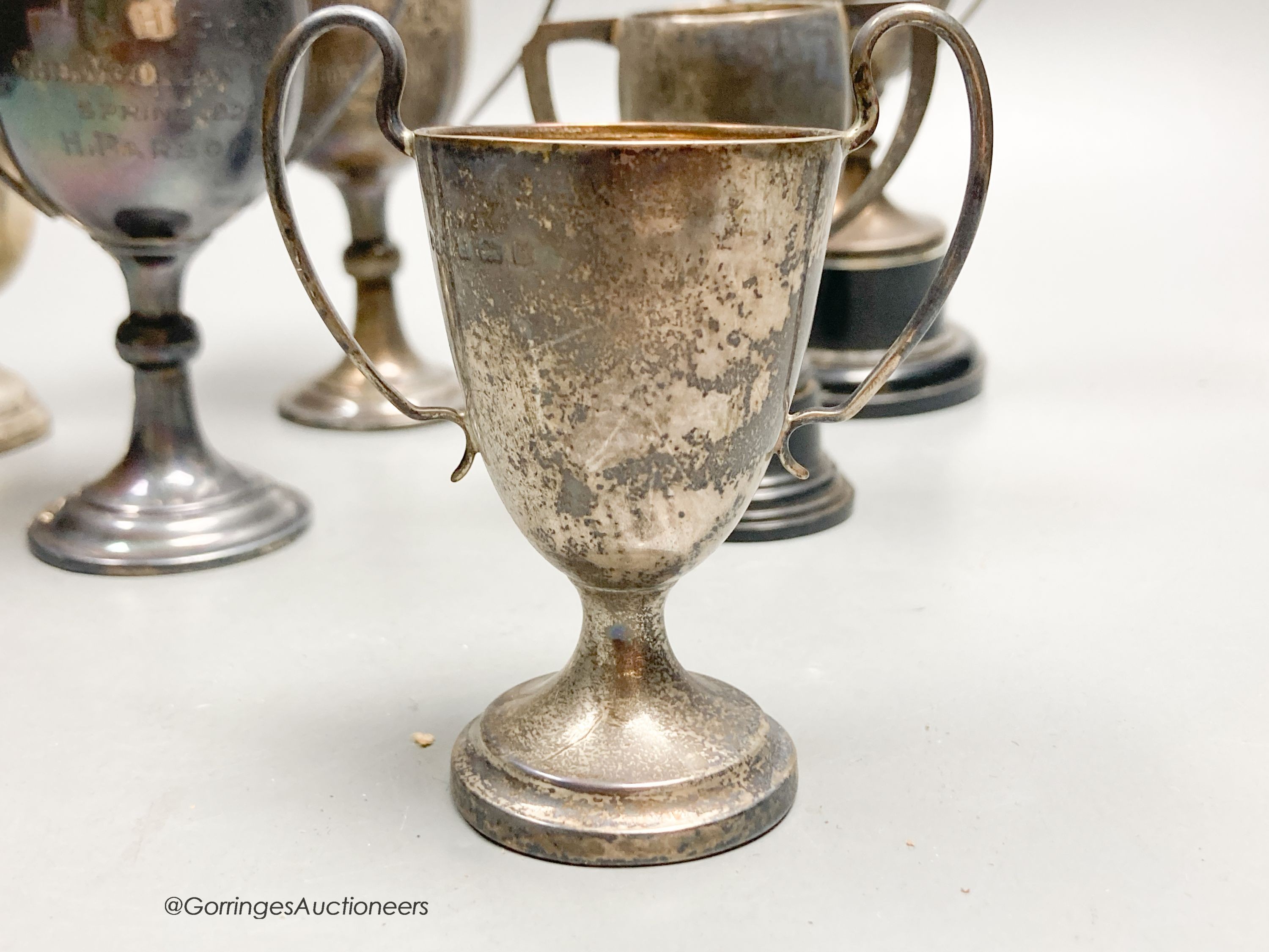 Eight assorted small silver trophy cups and one plated cup, tallest 11.3cm, 11.5oz.